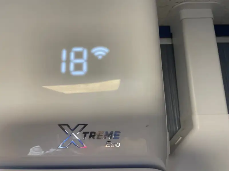 Air conditioner display set to 18°C on an energy-efficient split system