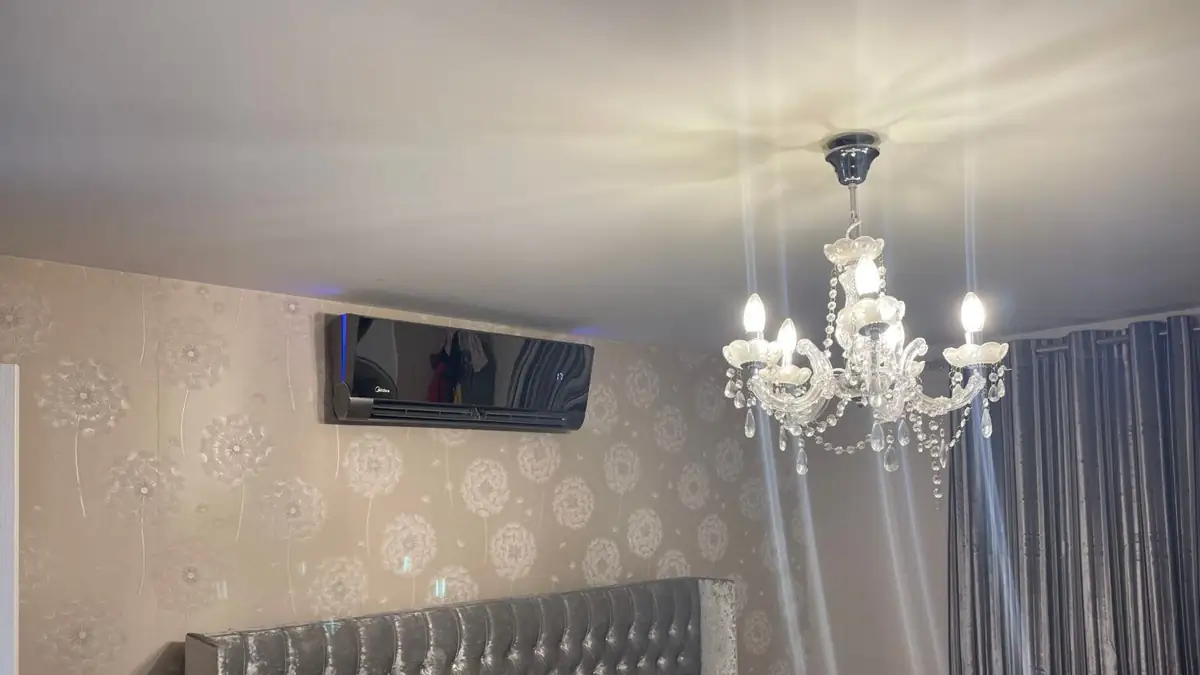 Home air conditioning unit installed above the bed in a Manchester bedroom